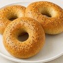 BagelsIngredients• 1 cup warm water• 2 tsp sugar• 1 tsp active dry yeast• 1¾ cups bread flour• 1 tsp saltInstructions1. Activate the yeast:Mix warm water, sugar, and yeast. Let it rest for about 10 minutes until frothy.2. Make the dough:Add bread flour and salt. Knead until smooth and elastic (about 8–10 minutes).3. First rise:Cover the dough and let it rise in a warm place for 1 hour, or until doubled in size.4. Shape the bagels:Divide the dough into 3–4 portions. Roll each into a ball, poke a hole in the center, and stretch into a ring shape.5. Boil the bagels:Boil each bagel in water for about 1 minute per side. This gives them their chewy texture.6. Bake:Place on a baking tray, brush with egg wash (optional), and bake at 200°C (400°F) for 15–18 minutes, or until golden brown