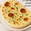 Naan Flat BreadIngredients• 2 cups all-purpose flour• ¼ cup plain yogurt• ¼ cup warm water• ½ tsp baking powder• ½ tsp saltInstructions1. Prepare the dough:Combine flour, salt, and baking powder. Add yogurt and water gradually to form a soft dough.2. Knead:Knead for about 5 minutes until smooth. Cover and let it rest for 30 minutes.3. Shape the naan:Divide into small balls and roll each into an oval or round shape.4. Cook:Heat a skillet or tawa over medium heat. Place the naan and cook until bubbles form, then flip.5. Optional finishing:Brush with butter or ghee and sprinkle with herbs or garlic. Serve warm.