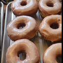 Glazed DonutsINGREDIENTS NEEDED: 1 package (.25-ounce) active dry yeast (2 ¼ teaspoons) 1/4 cup lukewarm water 1 1/2 cups whole milk, scalded and cooled down 1/2 cup granulated sugar 3 large eggs (room temperature) 5 to 5 ½ cups all-purpose flour 1 teaspoon salt 1/2 cup (1 stick) unsalted butter softenedDonut Icing 3 cups powdered sugar 1 teaspoon pure vanilla extract 3-5 tablespoons whole milkIn a large mixing bowl of a stand mixer dissolve the yeast in the warm water. Add the warm milk, sugar, and eggs. Add the dough hook attachment, and stir in the flour and salt. Cut the butter into small pieces and incorporate into the dough. Scrape the bowl a few times. Beat the dough until it becomes smooth, about 5-7 minutes.Turn the dough out onto a floured work surface and knead for 3-5 minutes, making a smooth dough. This dough is going to be sticky when you turn it out.Shape into a round ball and place into the greased mixing bowl. Cover with plastic wrap or disposable shower cap and clean kitchen towel. Place in a warm area and let rise until doubled in size, about 1 to 1 ½ hours.Turn the dough out onto a lightly floured work surface and knead the dough for a few minutes. Turn back into the greased bowl (spray with cooking spray again if needed) and let rise until doubled, about 1 hour.Whisk together your icing. Cover with plastic wrap and set aside.Turn the dough out onto a lightly floured surface, and roll out the dough to about 1/2-inch thickness. Cut out donuts and place onto a prepared baking sheet. Let the donuts rise until doubled.Line a baking pan with several layers of paper towels and set aside. In a large skillet, add about 3-inches of canola oil. Heat to 375-degrees F. Carefully drop about donuts into the oil, making sure not to overcrowd. Cook for 1 to 2 minutes on each side, or until lightly golden brown. Remove from the oil and allow them to drain on paper towels.Let cool slightly before dipping only the tops in the icing. Let drip dry on a cooling rack.